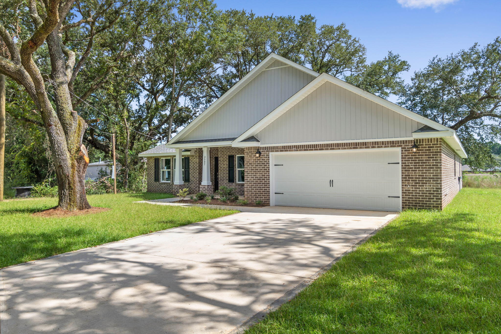 9158 Trident Road Milton, FL 32583 - Photo 6 of 41 a house with green field in front of it
