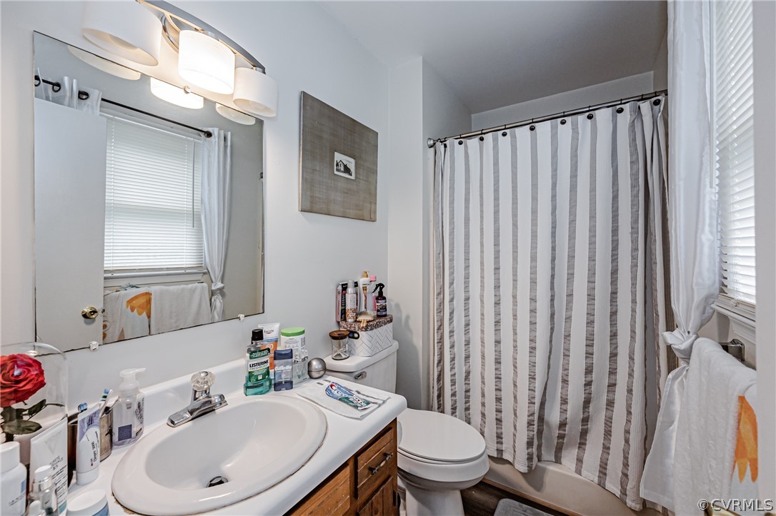 3902 Echo Ridge Court Midlothian, VA 23112 - Photo 19 of 42 a bathroom with a sink a toilet and shower curtain
