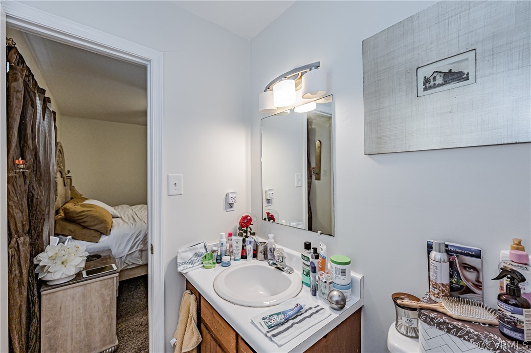 3902 Echo Ridge Court Midlothian, VA 23112 - Photo 20 of 42 a bathroom with a sink toilet and mirror