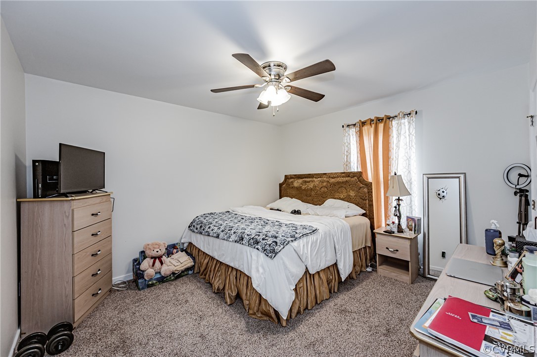 3902 Echo Ridge Court Midlothian, VA 23112 - Photo 21 of 42 a bedroom with a bed and a chandelier