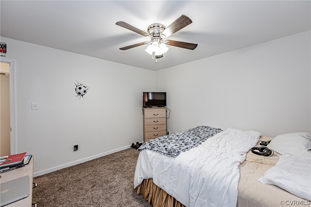 3902 Echo Ridge Court Midlothian, VA 23112 - Photo 22 of 42 a bedroom with a bed and a chandelier