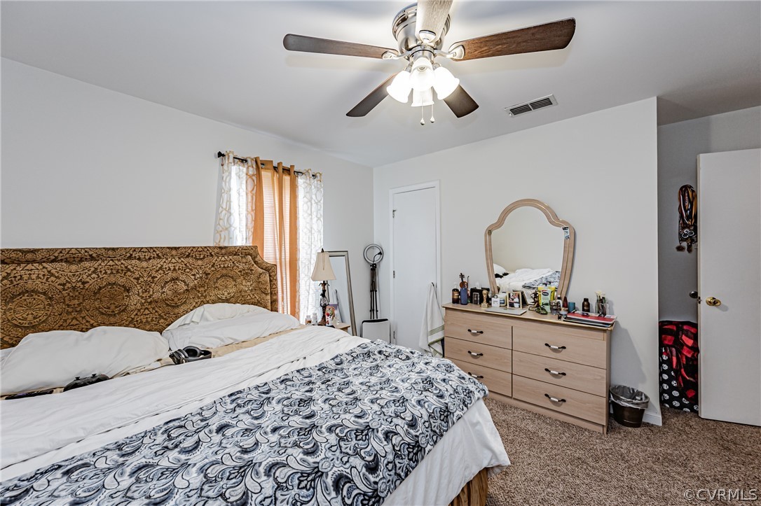 3902 Echo Ridge Court Midlothian, VA 23112 - Photo 23 of 42 a bedroom with a large bed and a chandelier