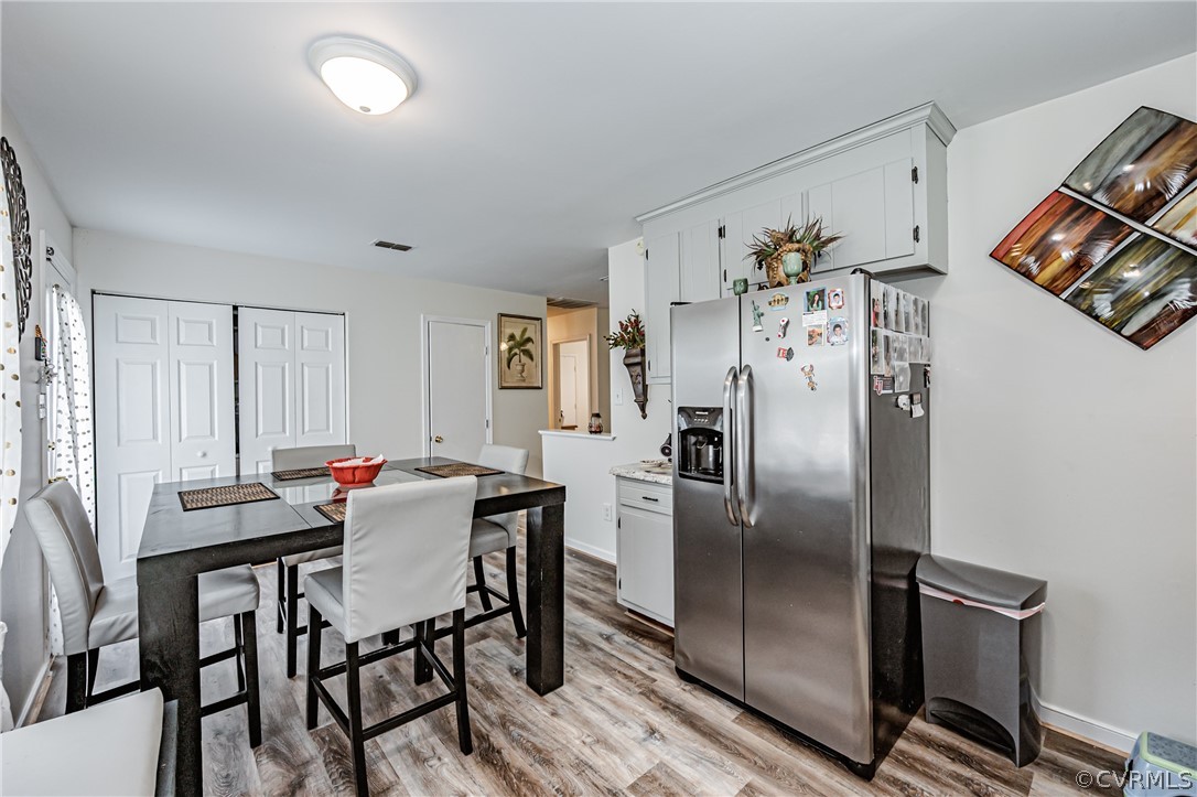 3902 Echo Ridge Court Midlothian, VA 23112 - Photo 35 of 42 a kitchen with stainless steel appliances a refrigerator a table and chairs