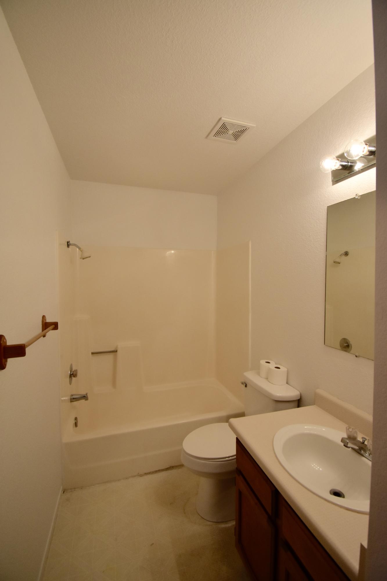 1253 Woodside Meadows Road Redding, CA 96002 - Photo 11 of 32 a bathroom with a granite countertop sink a toilet and shower