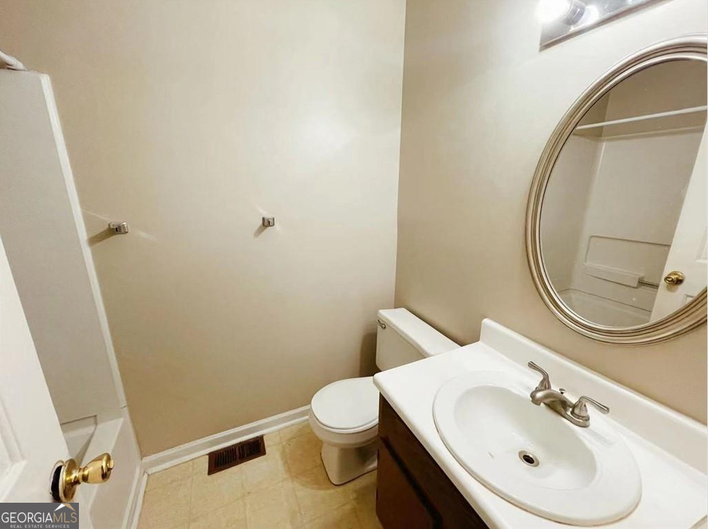 1857 Grant Court Kennesaw, GA 30144 - Photo 9 of 14 a bathroom with a sink mirror vanity and toilet