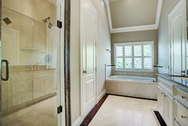 a bathroom with a tub shower and sink
