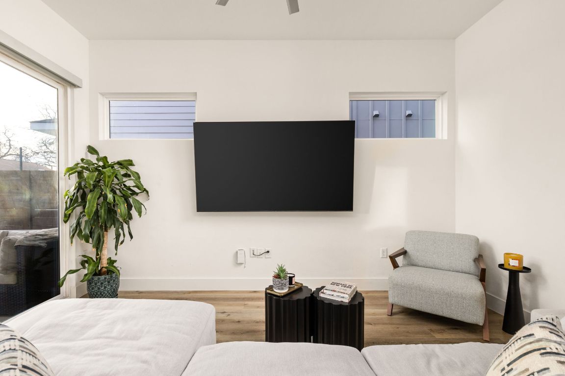 5109 Glissman Road, Unit 1 Austin, TX 78702 - Photo 12 of 39 Living area featuring wood finished floors and a ceiling fan