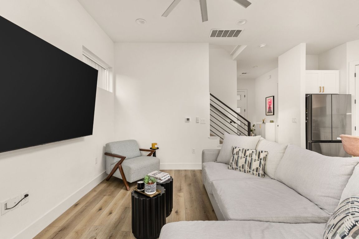 5109 Glissman Road, Unit 1 Austin, TX 78702 - Photo 14 of 39 Living area featuring light wood-type flooring, ceiling fan, and stairs