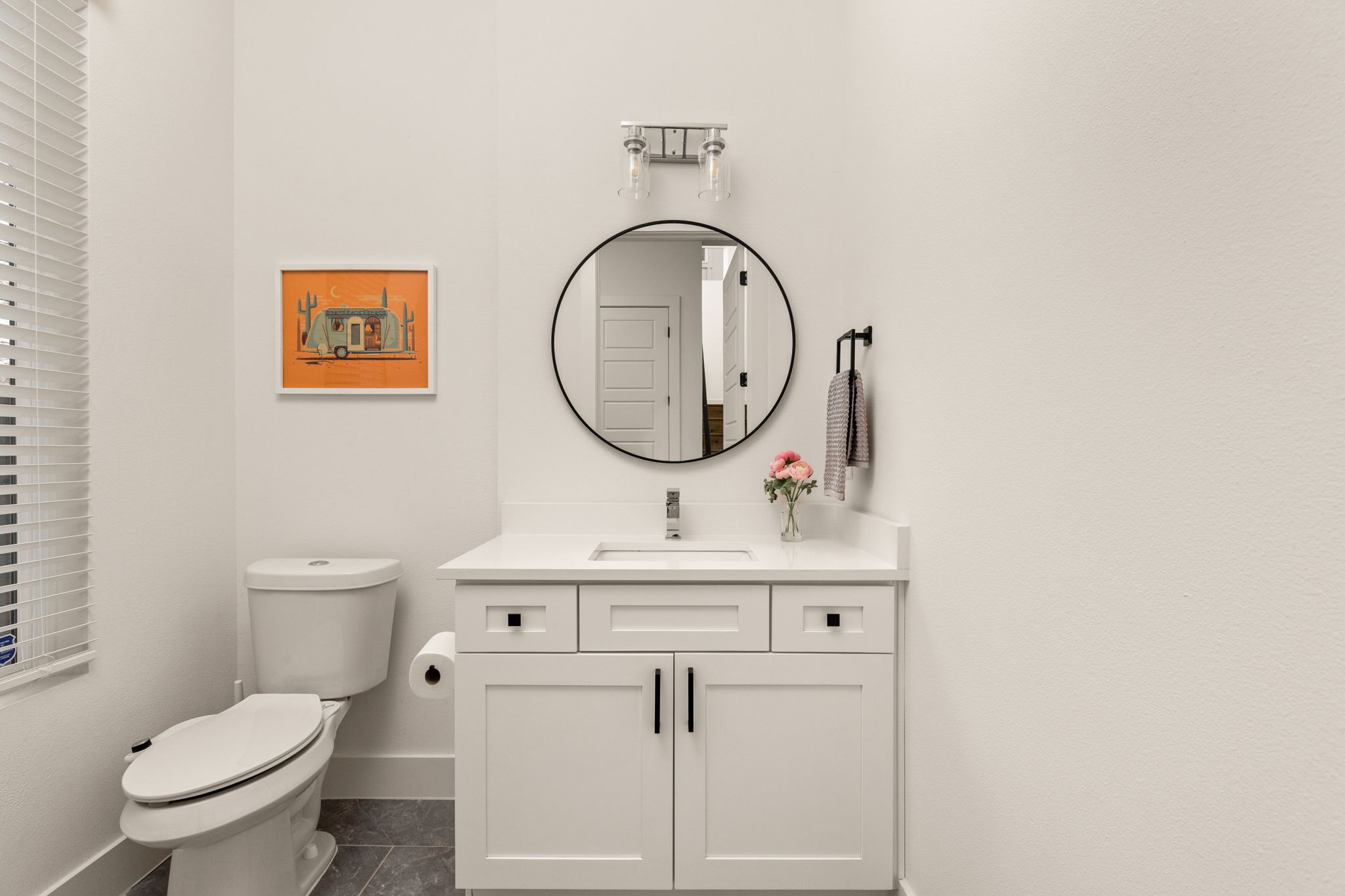 5109 Glissman Road, Unit 1 Austin, TX 78702 - Photo 15 of 39 a bathroom with a toilet a sink and a mirror
