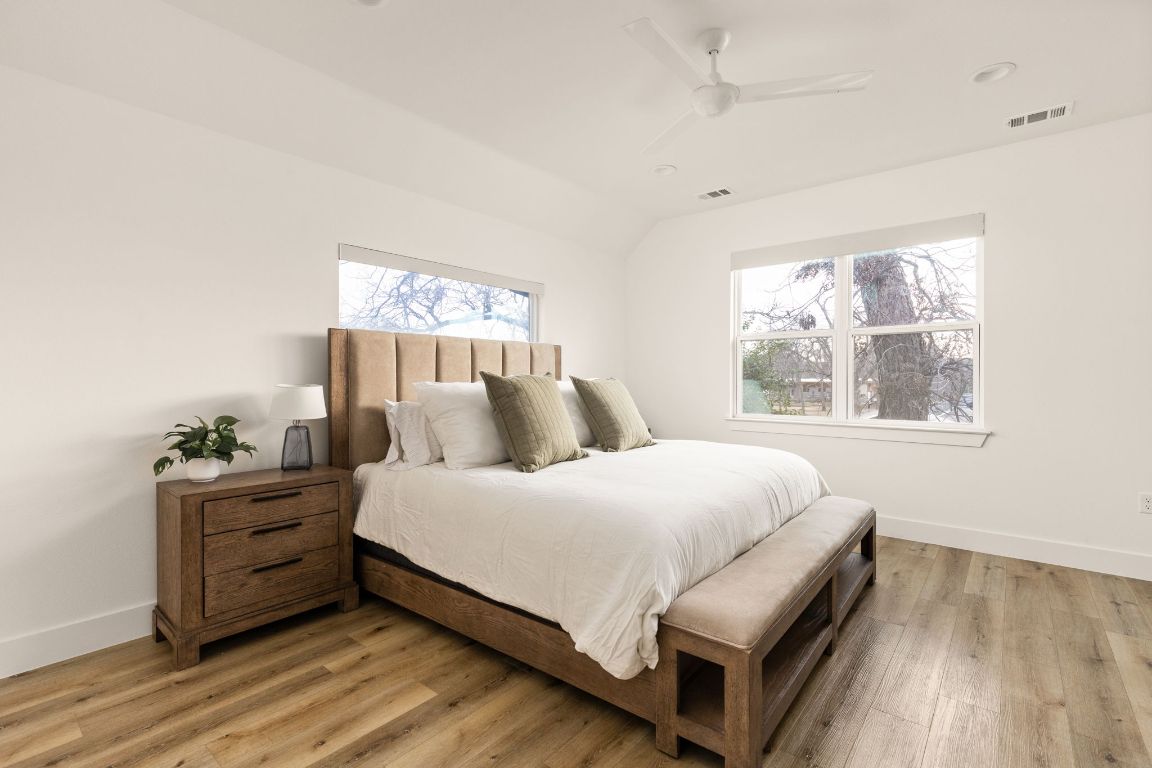 5109 Glissman Road, Unit 1 Austin, TX 78702 - Photo 16 of 39 Bedroom with light wood-style flooring, a ceiling fan, and lofted ceiling