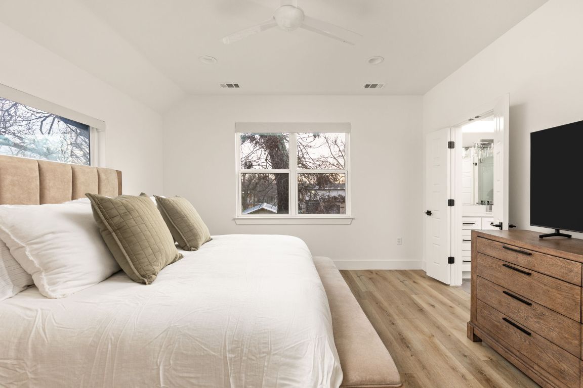 5109 Glissman Road, Unit 1 Austin, TX 78702 - Photo 17 of 39 Bedroom featuring light wood-style flooring and a ceiling fan