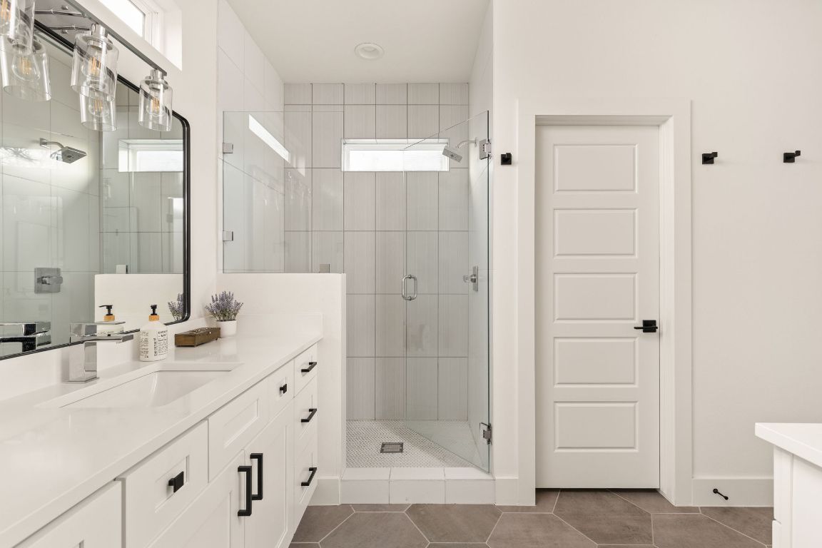 5109 Glissman Road, Unit 1 Austin, TX 78702 - Photo 19 of 39 Bathroom with vanity, a stall shower, and dark tile patterned flooring