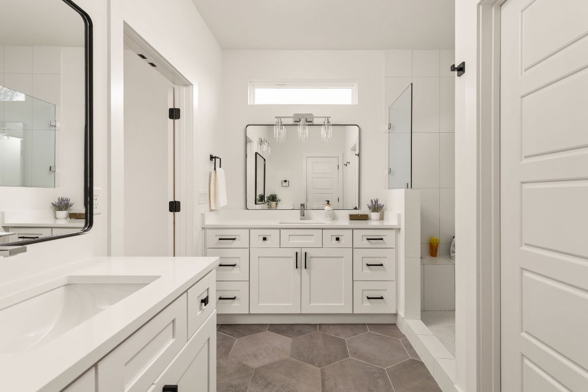 5109 Glissman Road, Unit 1 Austin, TX 78702 - Photo 20 of 39 Bathroom featuring a stall shower, two vanities, and dark tile patterned floors