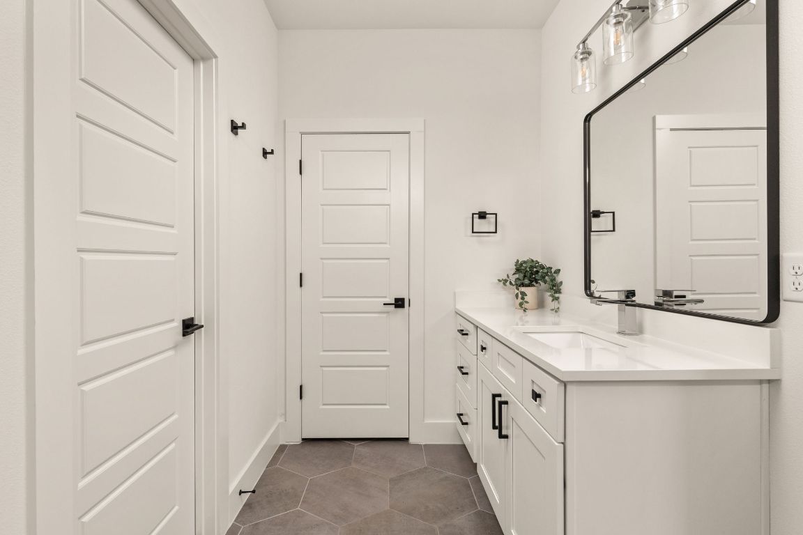5109 Glissman Road, Unit 1 Austin, TX 78702 - Photo 21 of 39 Bathroom with vanity and dark tile patterned flooring