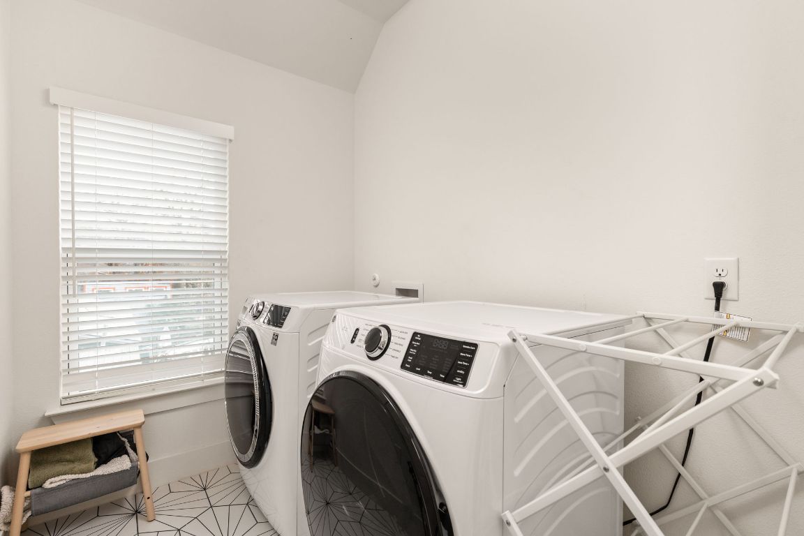5109 Glissman Road, Unit 1 Austin, TX 78702 - Photo 25 of 39 Laundry area with vaulted ceiling, independent washer and dryer, and light tile patterned floors
