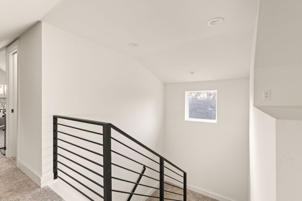 5109 Glissman Road, Unit 1 Austin, TX 78702 - Photo 26 of 39 Stairway featuring carpet and recessed lighting