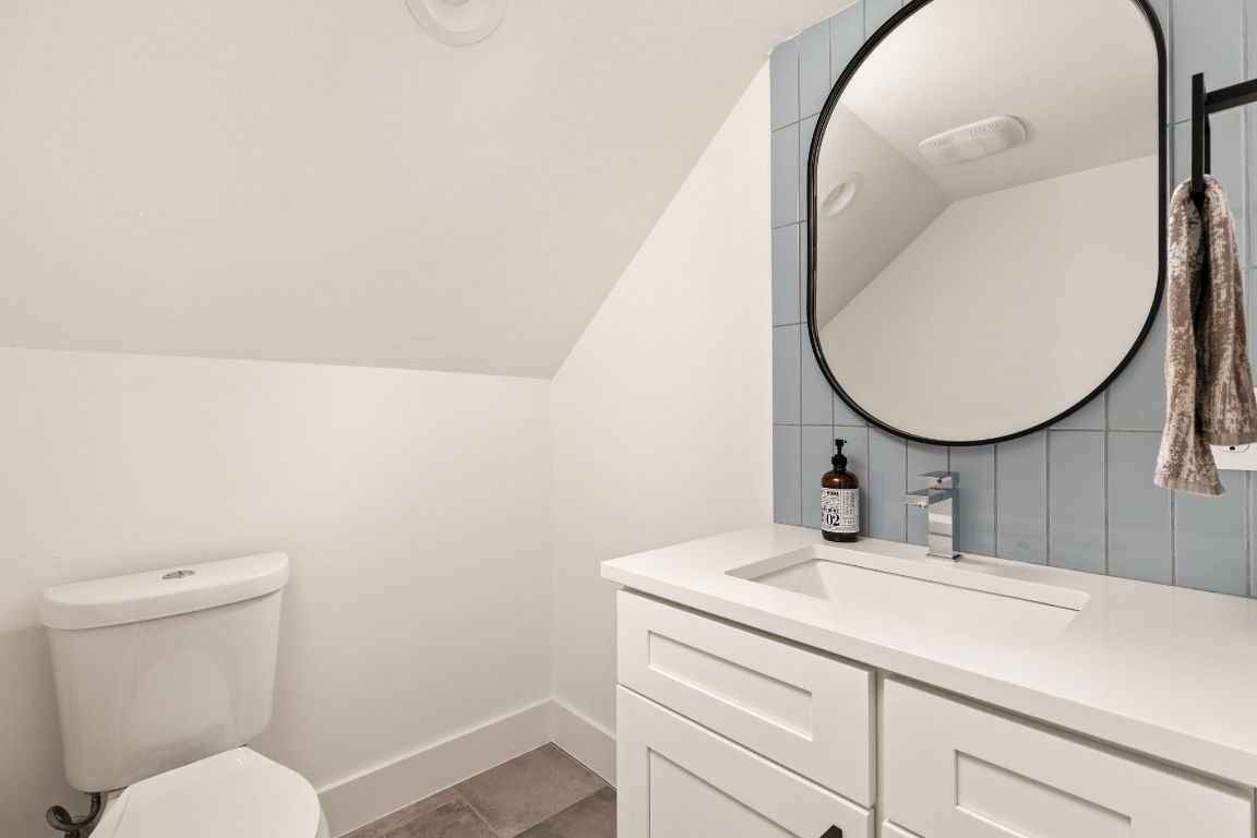 5109 Glissman Road, Unit 1 Austin, TX 78702 - Photo 29 of 39 Bathroom featuring vanity and vaulted ceiling