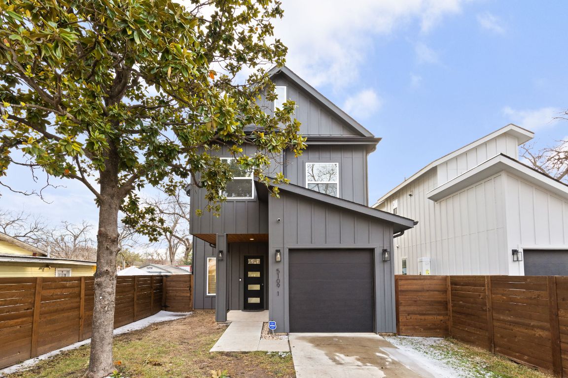 5109 Glissman Road, Unit 1 Austin, TX 78702 - Photo 35 of 39 View of front of house featuring board and batten siding and concrete driveway