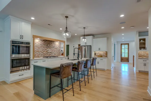 a view of a workspace with furniture and wooden floor