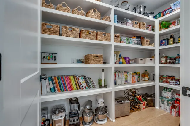 a living room with furniture and a book shelf