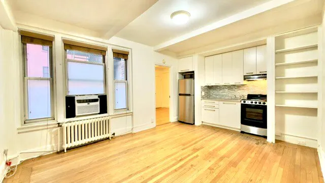 a view of a kitchen with a sink and a refrigerator