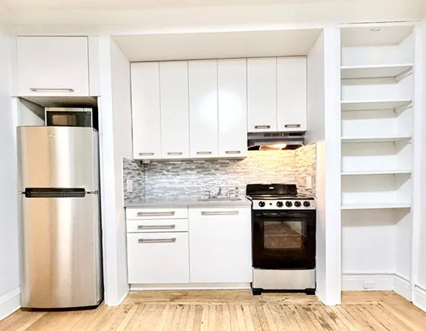a kitchen with a refrigerator and a stove