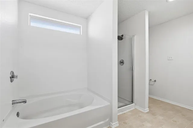 a white bath tub sitting next to a shower