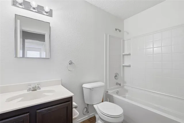 a bathroom with a sink toilet vanity and shower