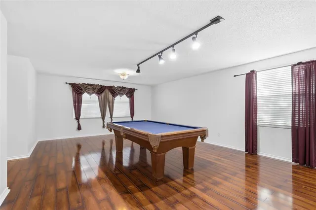 a room with wooden floor windows and a wooden floor