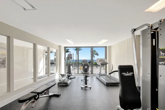 a view of a house with a swimming pool and sitting area