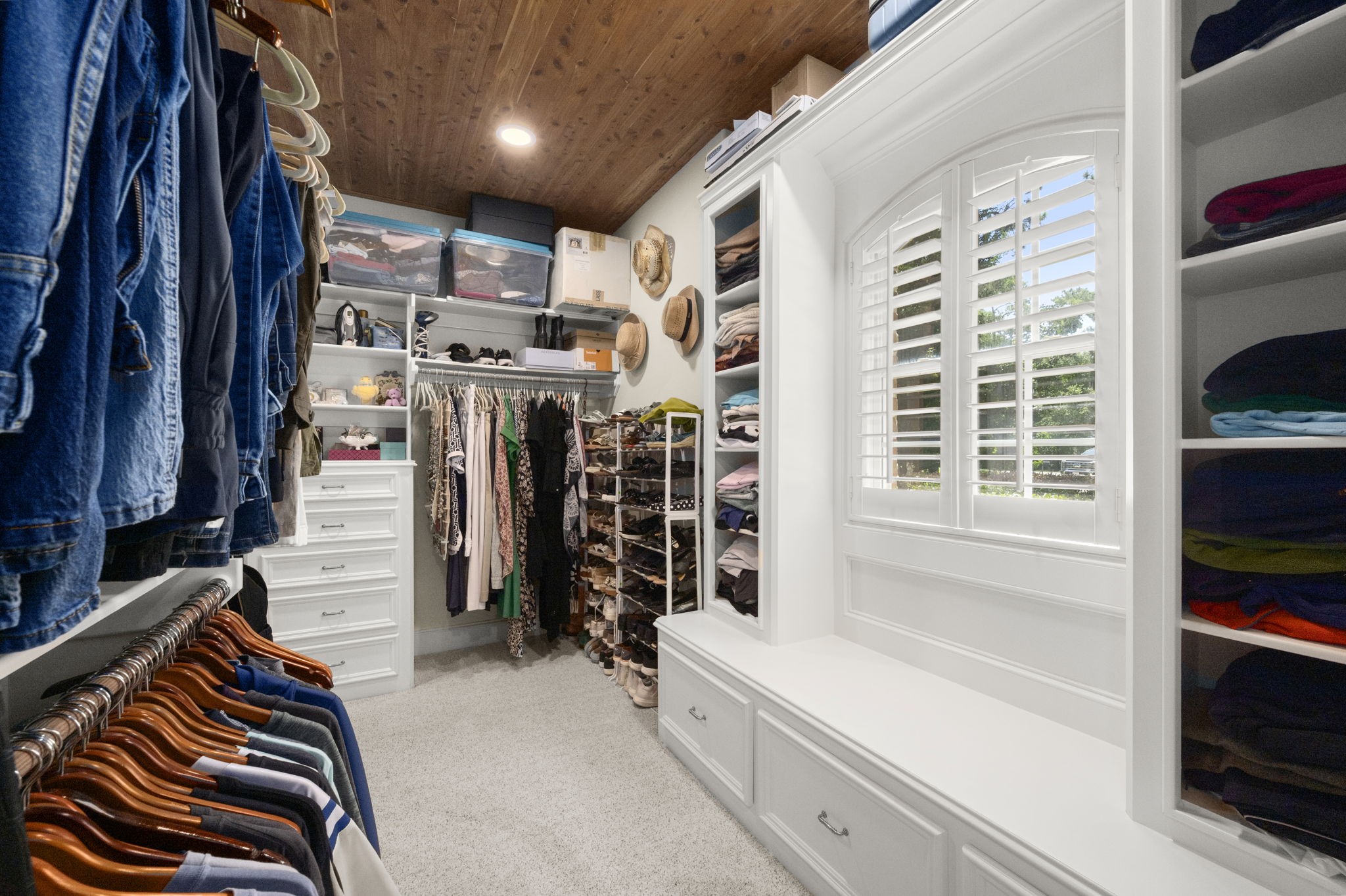 4106 Angling Lane Spring, TX 77386 - Photo 36 of 50 Spacious walk-in closet featuring custom shelving, ample hanging space, and a charming window seat with natural light.