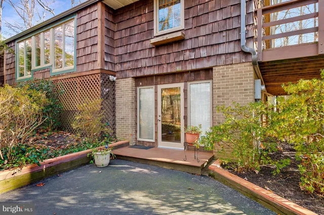 a view of a building with a large window and potted plants