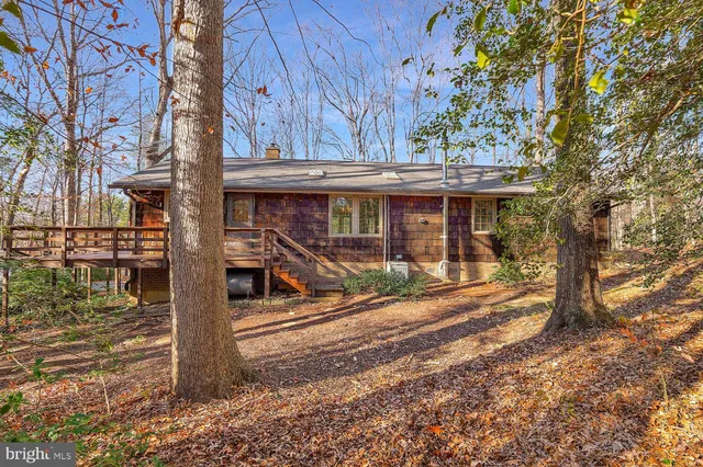 a view of a balcony with wooden floor and outdoor seating