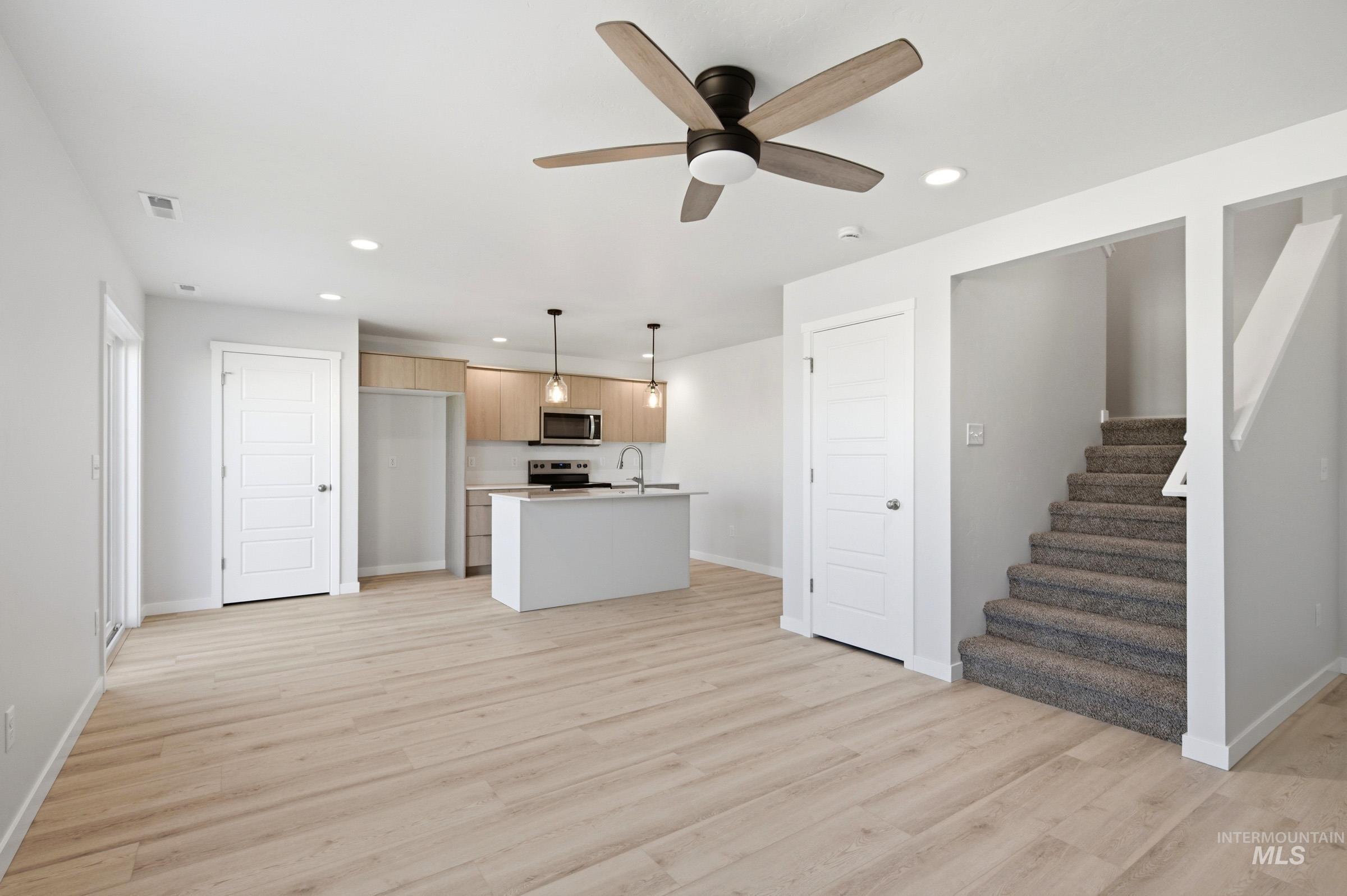 10800 Rutland Street Caldwell, ID 83605 - Photo 10 of 21 Expansive main living area featuring wood-finish flooring and a contemporary ceiling fan