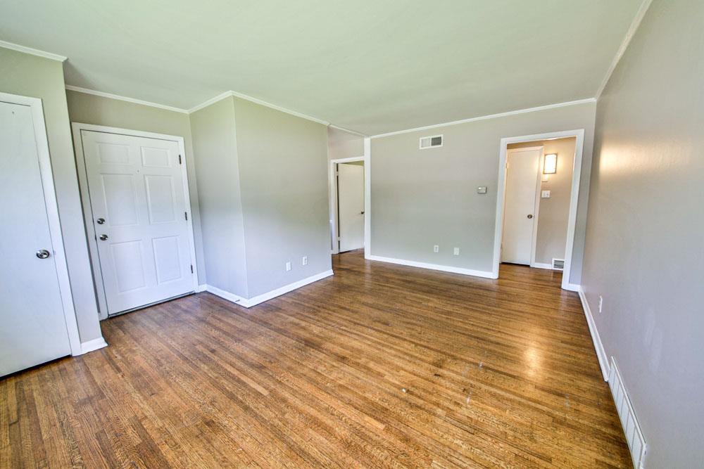 4773 Quince Road Memphis, TN 38117 - Photo 5 of 11 an empty room with wooden floor and entrance