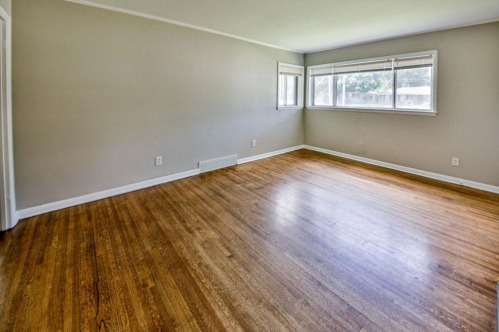 4773 Quince Road Memphis, TN 38117 - Photo 6 of 11 an empty room with wooden floor and windows