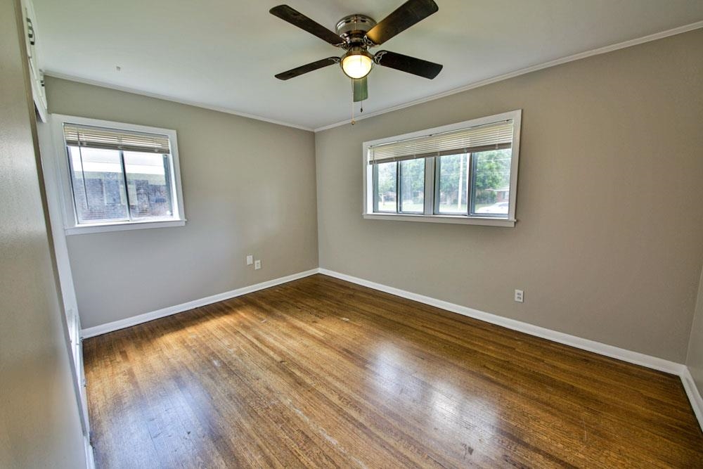 4773 Quince Road Memphis, TN 38117 - Photo 8 of 11 a view of empty room with wooden floor and fan