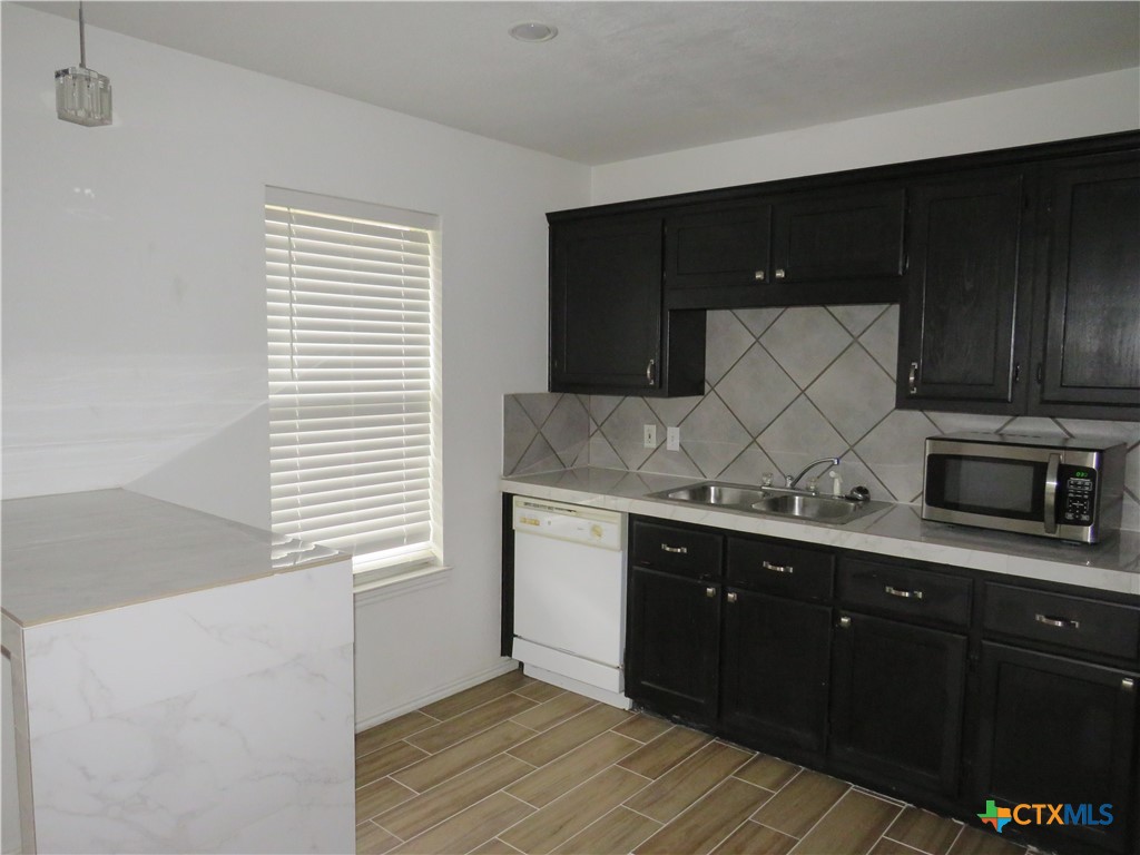 4608 Bowles Drive, Unit D Killeen, TX 76549 - Photo 5 of 15 a kitchen with a sink and cabinets