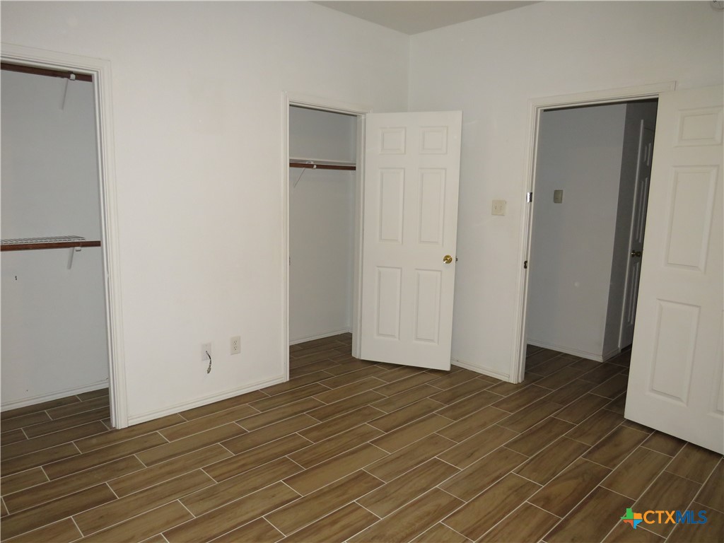 4608 Bowles Drive, Unit D Killeen, TX 76549 - Photo 8 of 15 a view of an empty room with wooden floor