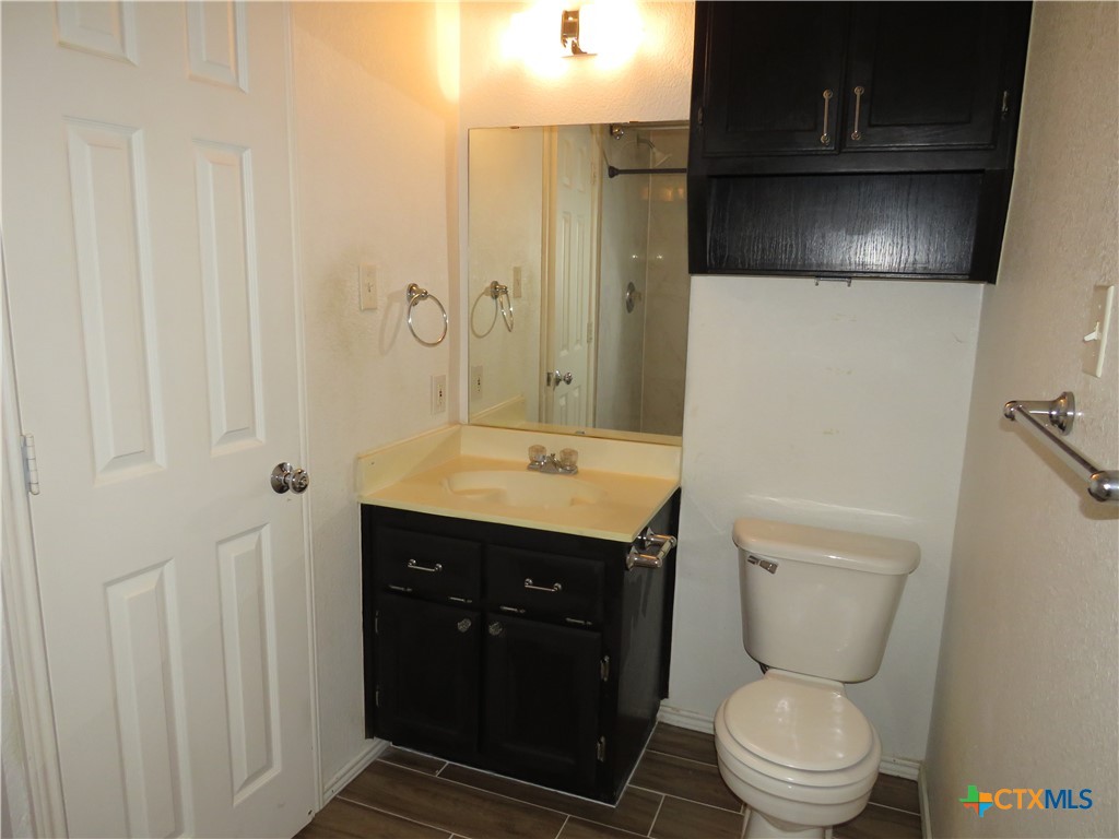 4608 Bowles Drive, Unit D Killeen, TX 76549 - Photo 10 of 15 a bathroom with a toilet sink and mirror