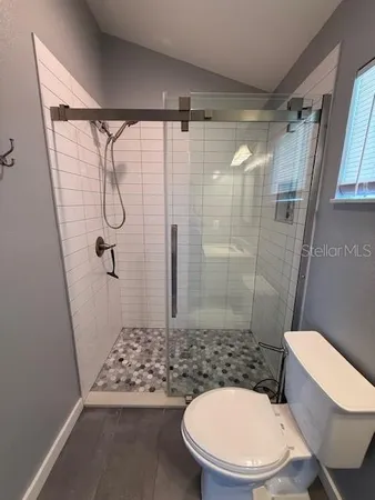 a bathroom with a toilet and shower