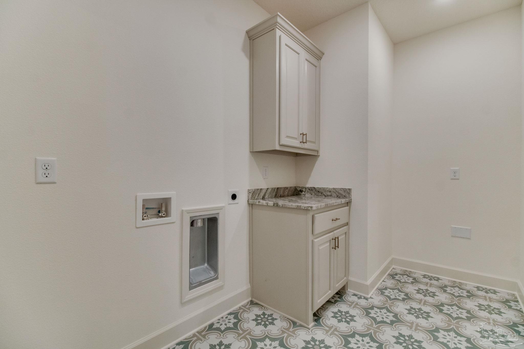 4310 Watkins Street Pace, FL 32571 - Photo 31 of 58 a kitchen with granite countertop white cabinets and white appliances