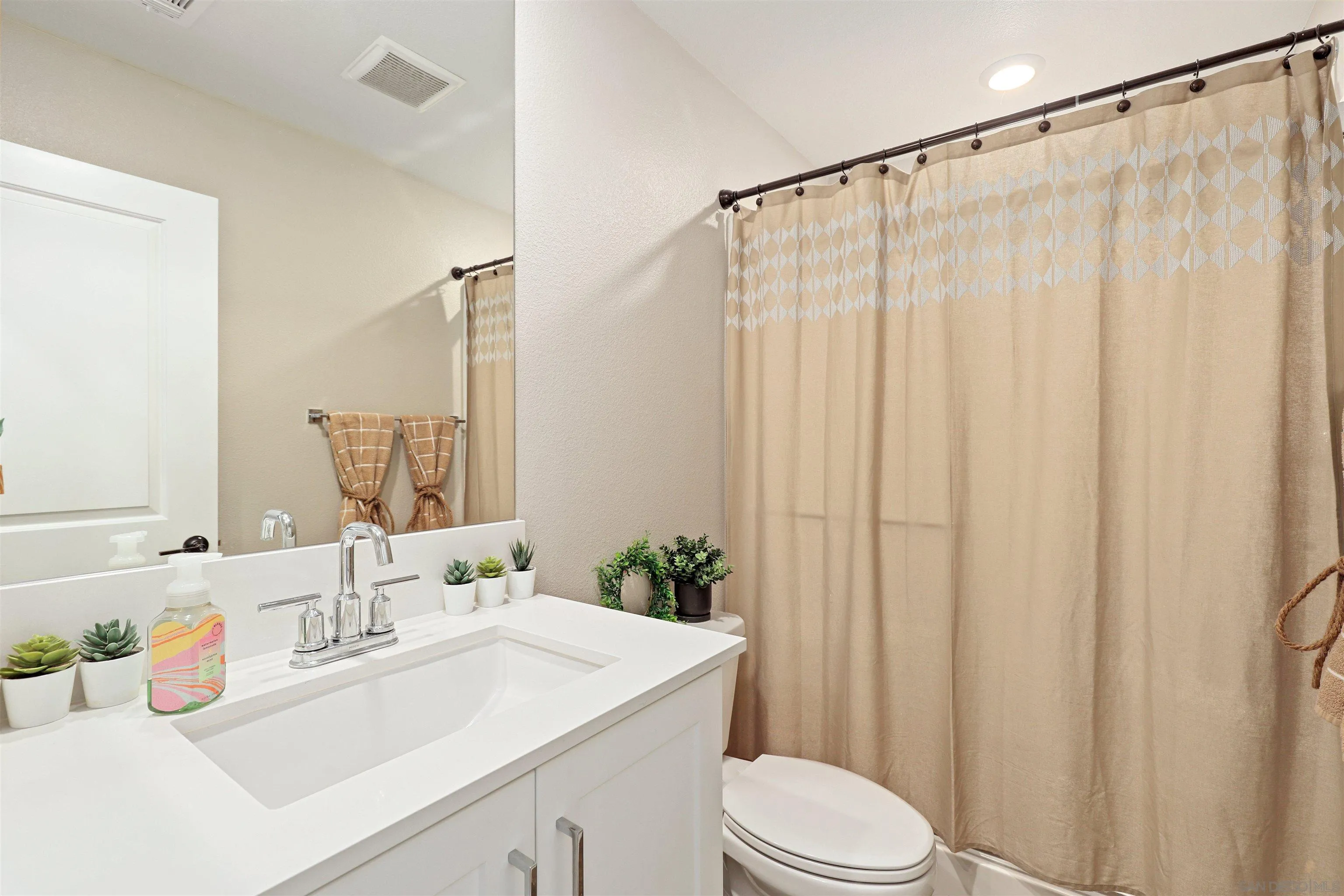 1799 Whitmore Loop Chula Vista, CA 91913 - Photo 17 of 36 a bathroom with a sink a toilet and a mirror