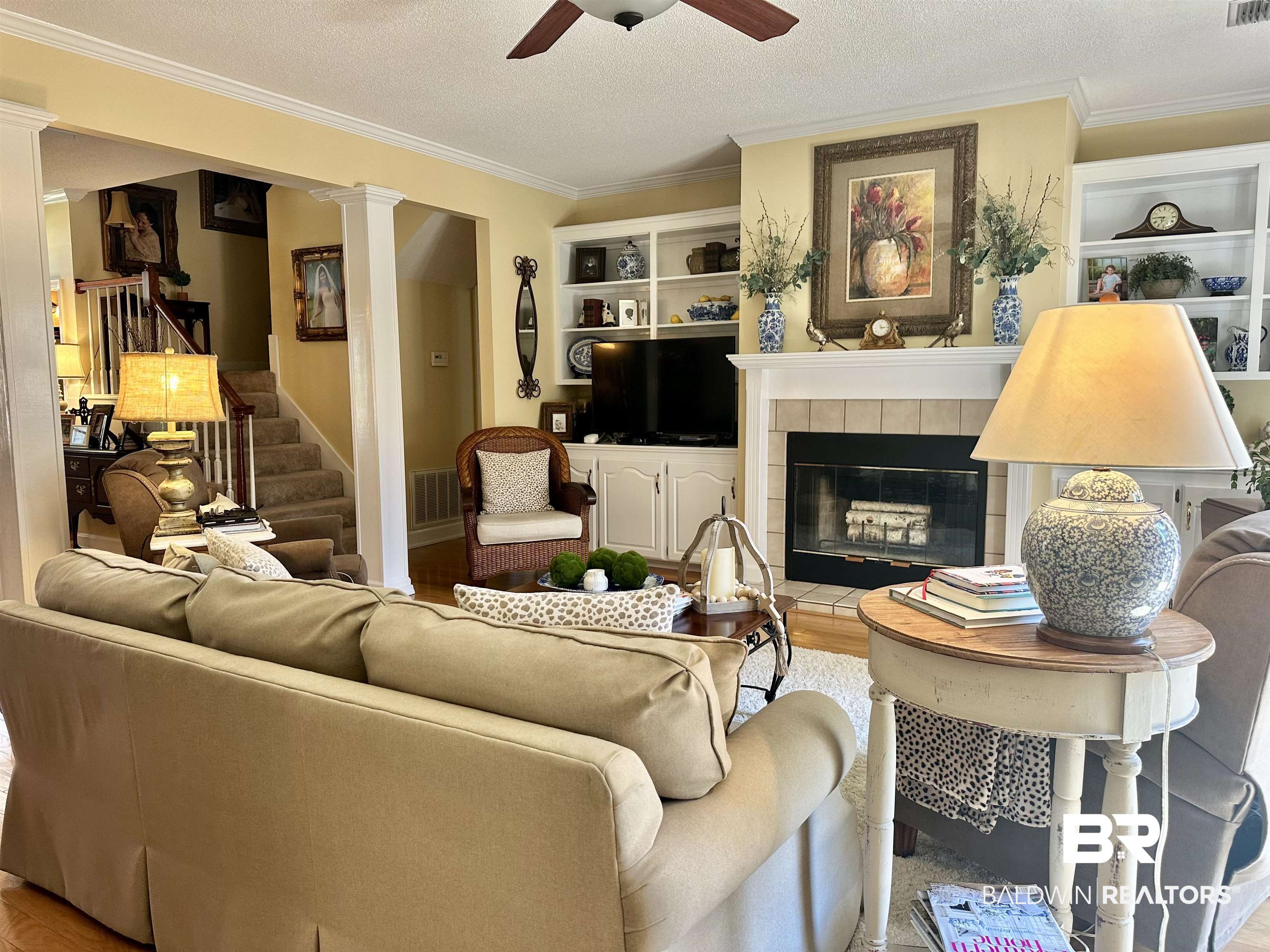 148 Brooks Boulevard Brewton, AL 36426 - Photo 5 of 45 Living area featuring a textured ceiling, wood finished floors, a ceiling fan, and ornamental molding