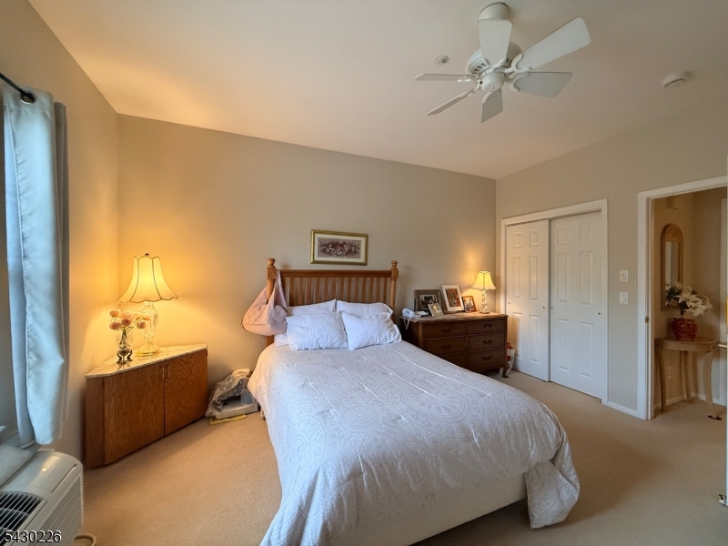 1302 Richmond Road, Unit 302 West Milford, NJ 07480 - Photo 8 of 21 a bedroom with a bed and a chandelier