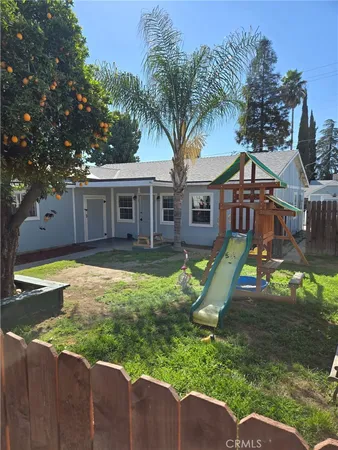 a view of a house with pool and a yard