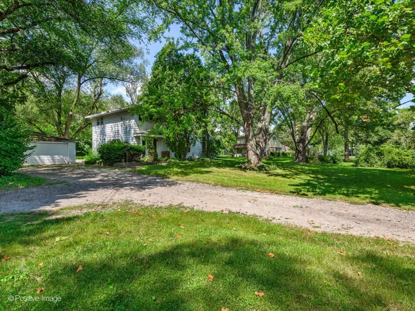a house with huge green field in front of it