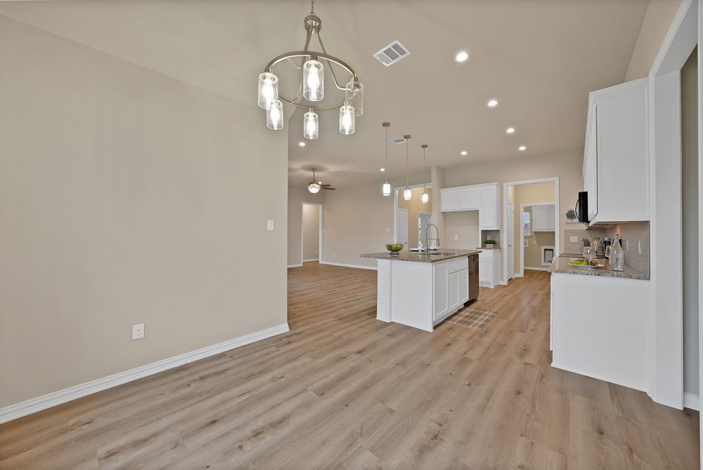 106 Panther Loop Mabank, TX 75147 - Photo 11 of 34 a view of kitchen and kitchen with granite countertop wooden floor