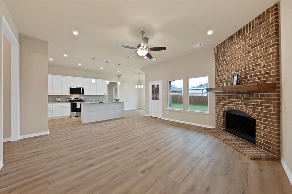 106 Panther Loop Mabank, TX 75147 - Photo 15 of 34 a view of an empty room with a kitchen and a fireplace