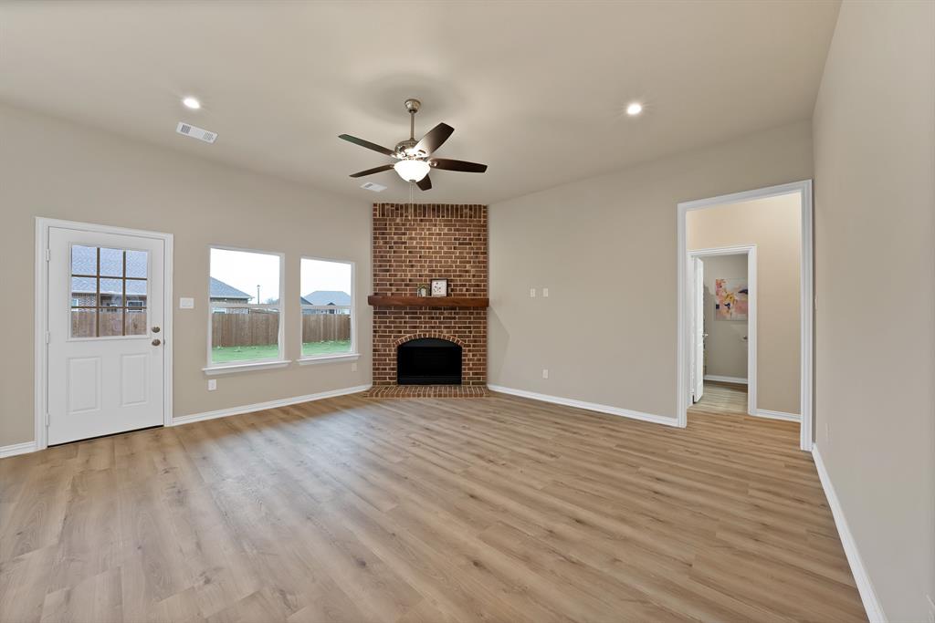 106 Panther Loop Mabank, TX 75147 - Photo 17 of 34 a view of an empty room with a window and wooden floor